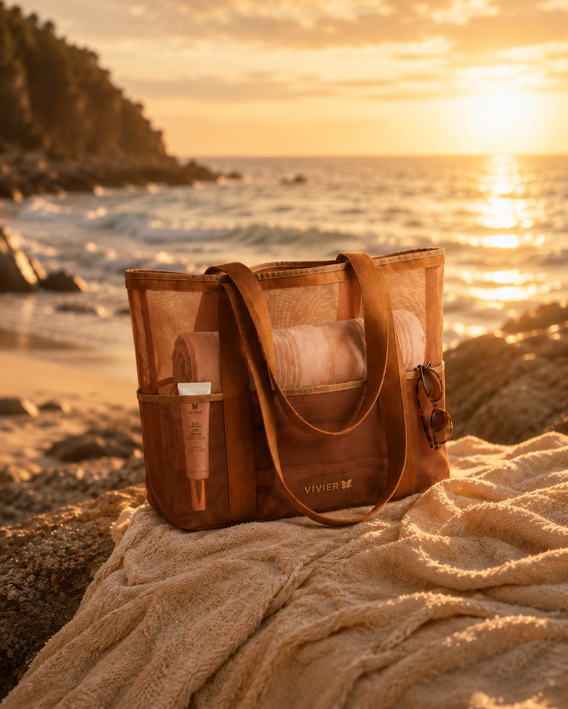 Bronze Vivier tote bag with visible brand logo on a sandy beach at sunset. - GWP 250+ on vivier products