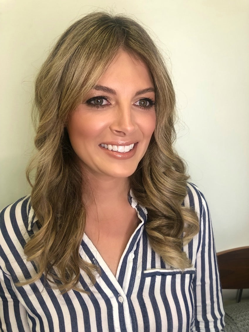 A smiling client who had her makeup professionally done at Foxy Face Studio