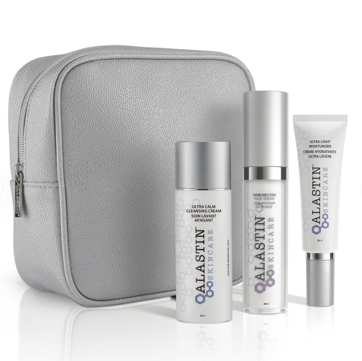 Alastin skincare products with a gray travel case on a white background, includes; Ultra calm cleansing cream, skin nectar, ultra light moisturizer