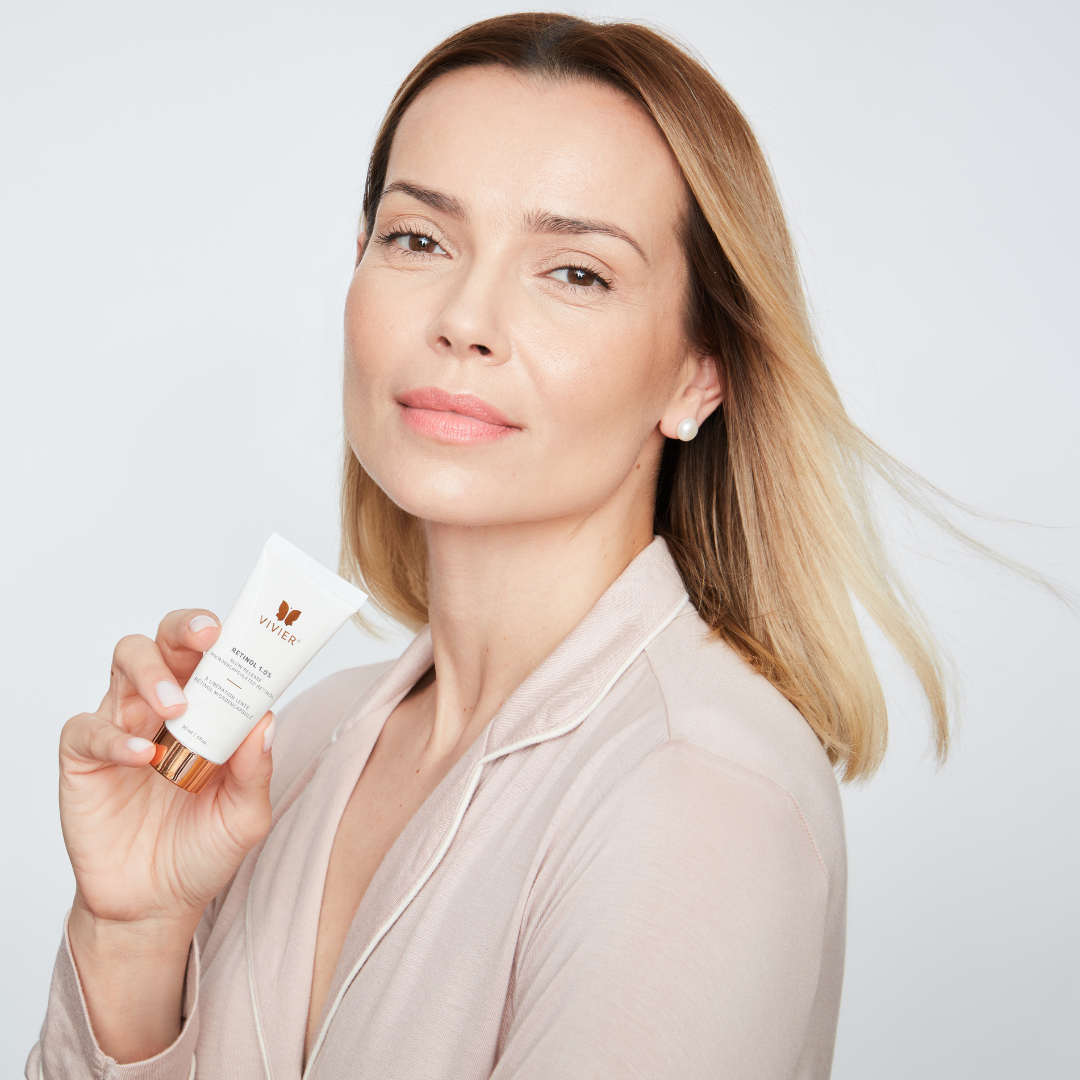 Image of a woman holding a Bottle of Viver Retinol 1.0% the best for AntiAging