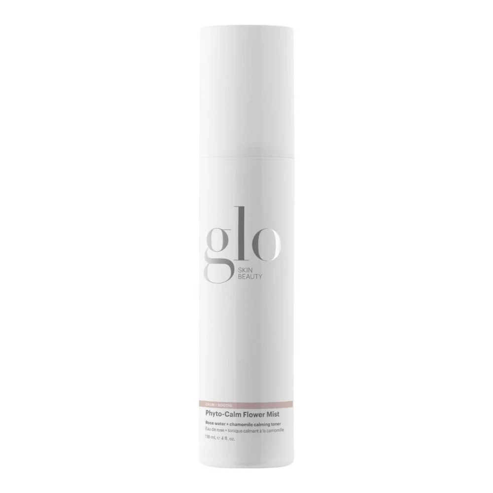 A white pump bottle labeled 'GLO BEAUTY Phyto-Calm Flower Mist' with rose water and chamomile as ingredients.